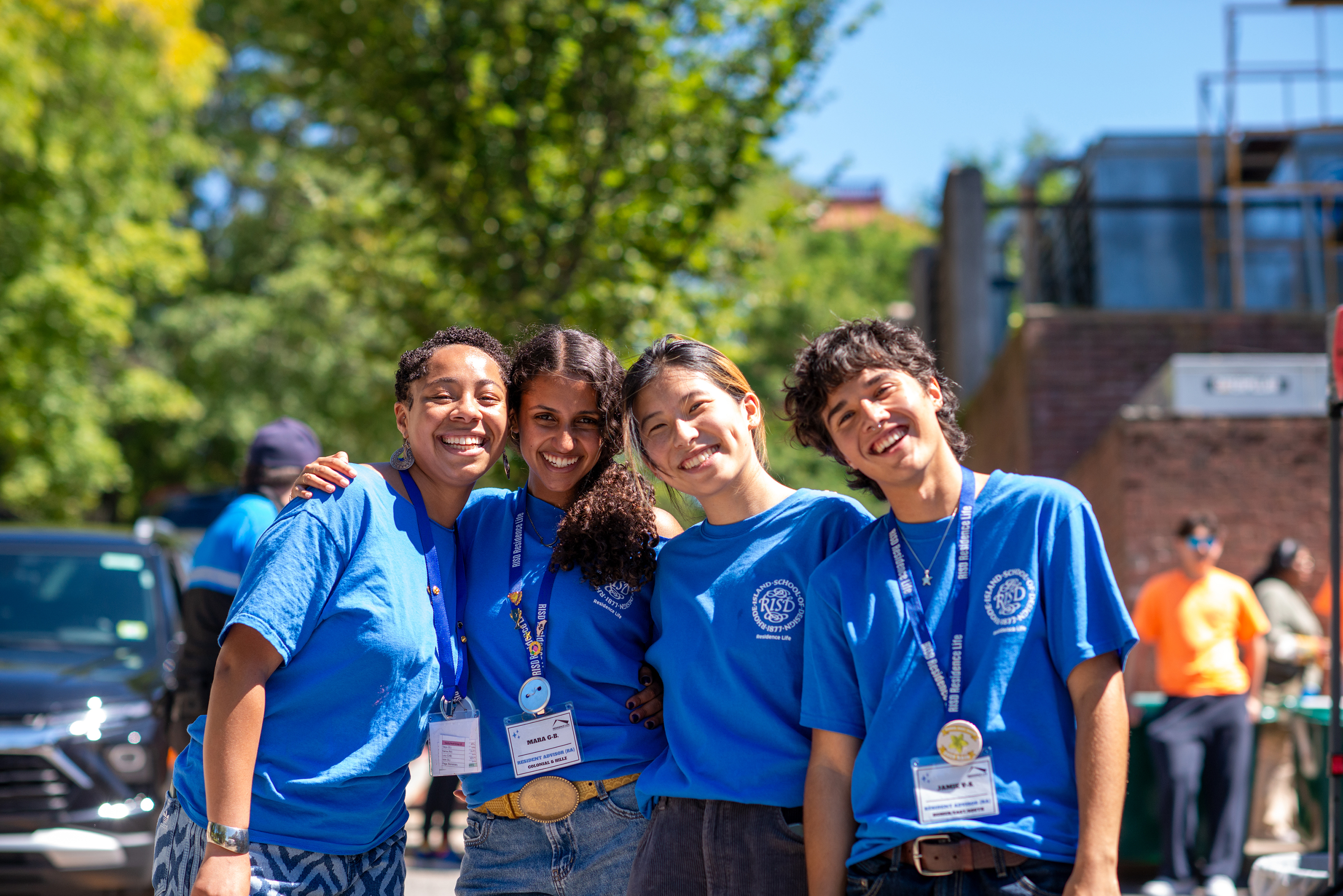 happy students in RISD blue welcome new students