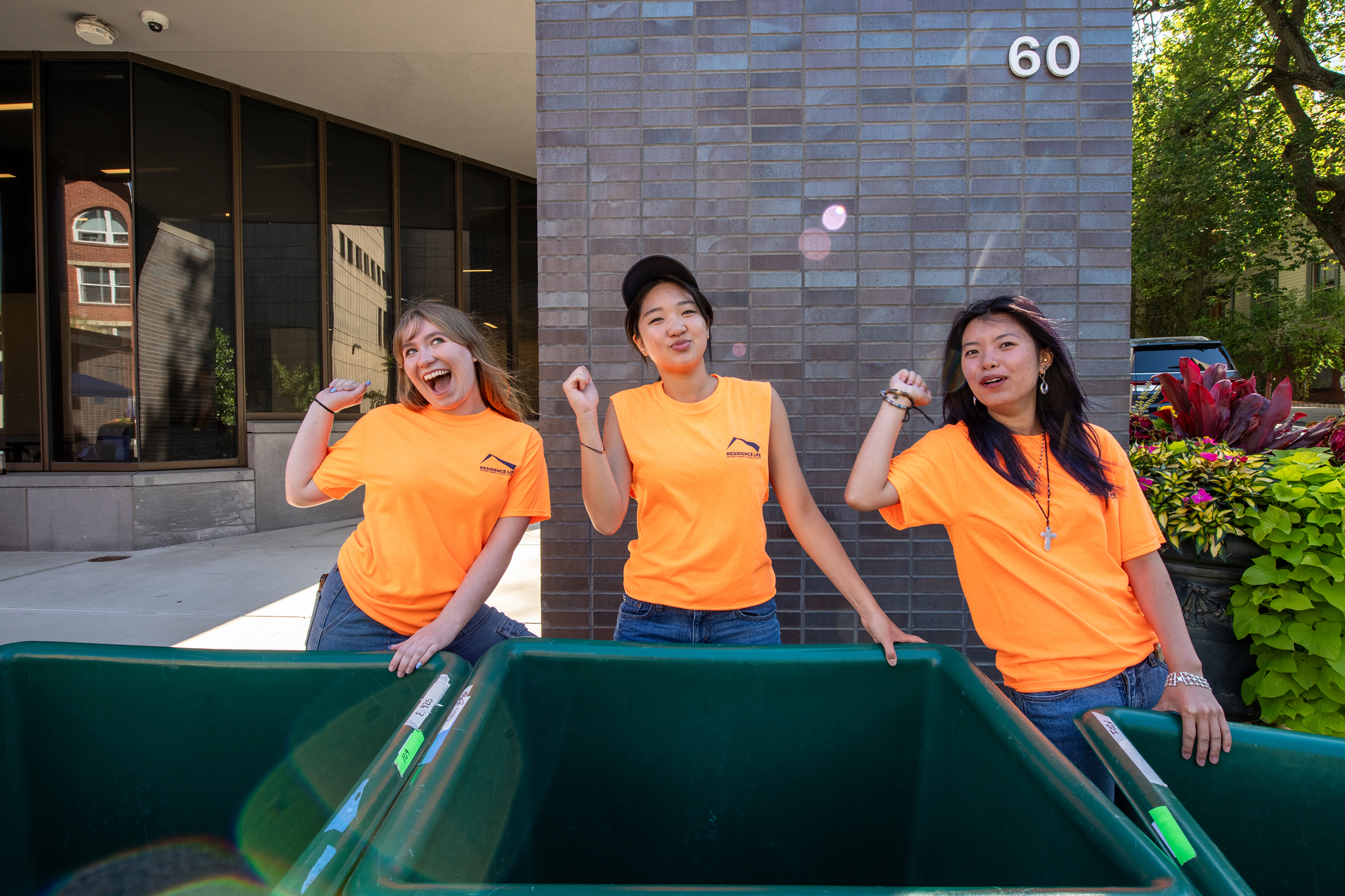 student volunteers ready with bins mug for the camera