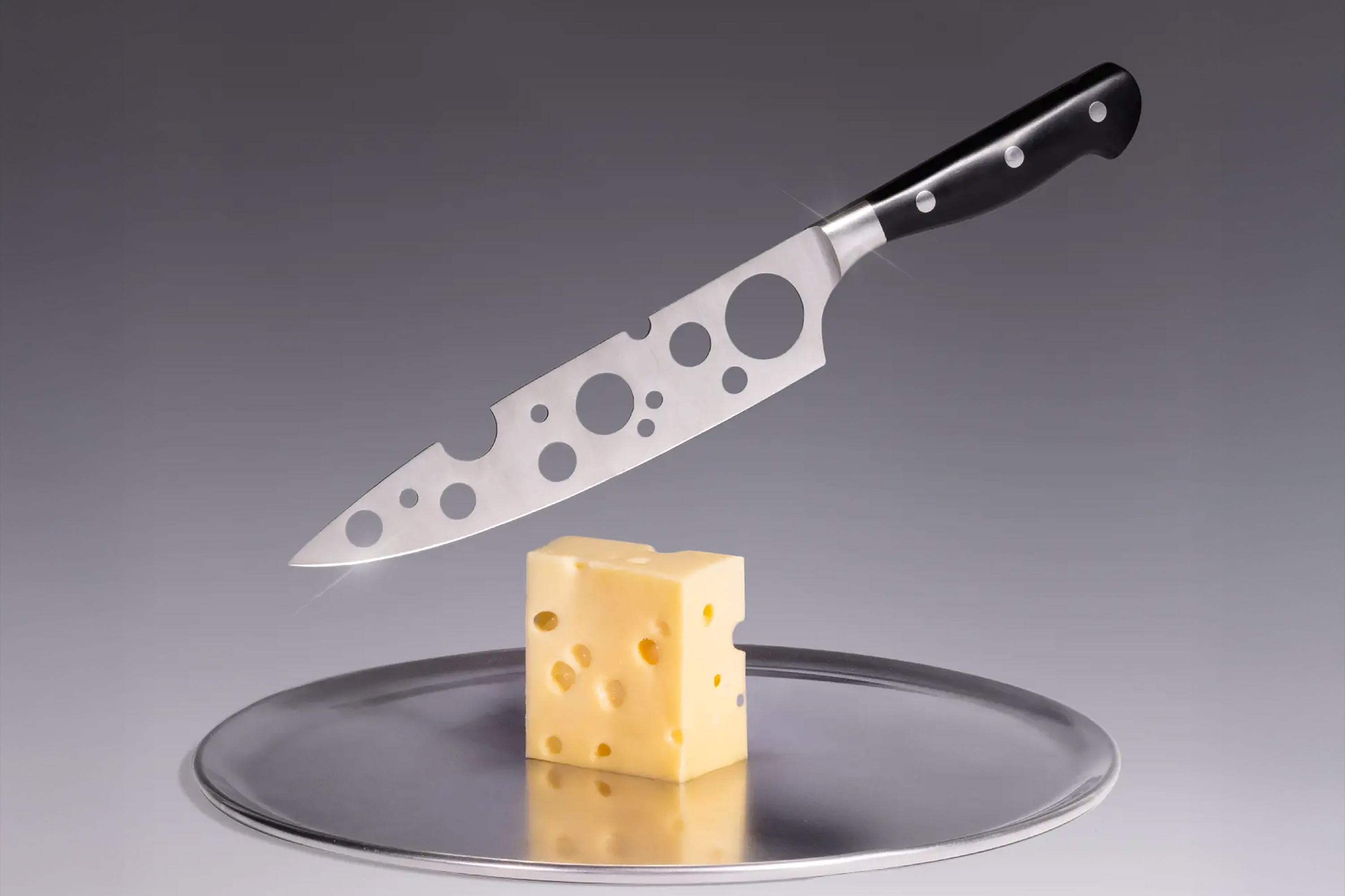 the Holey Cheese knife posed with a block of Swiss cheese