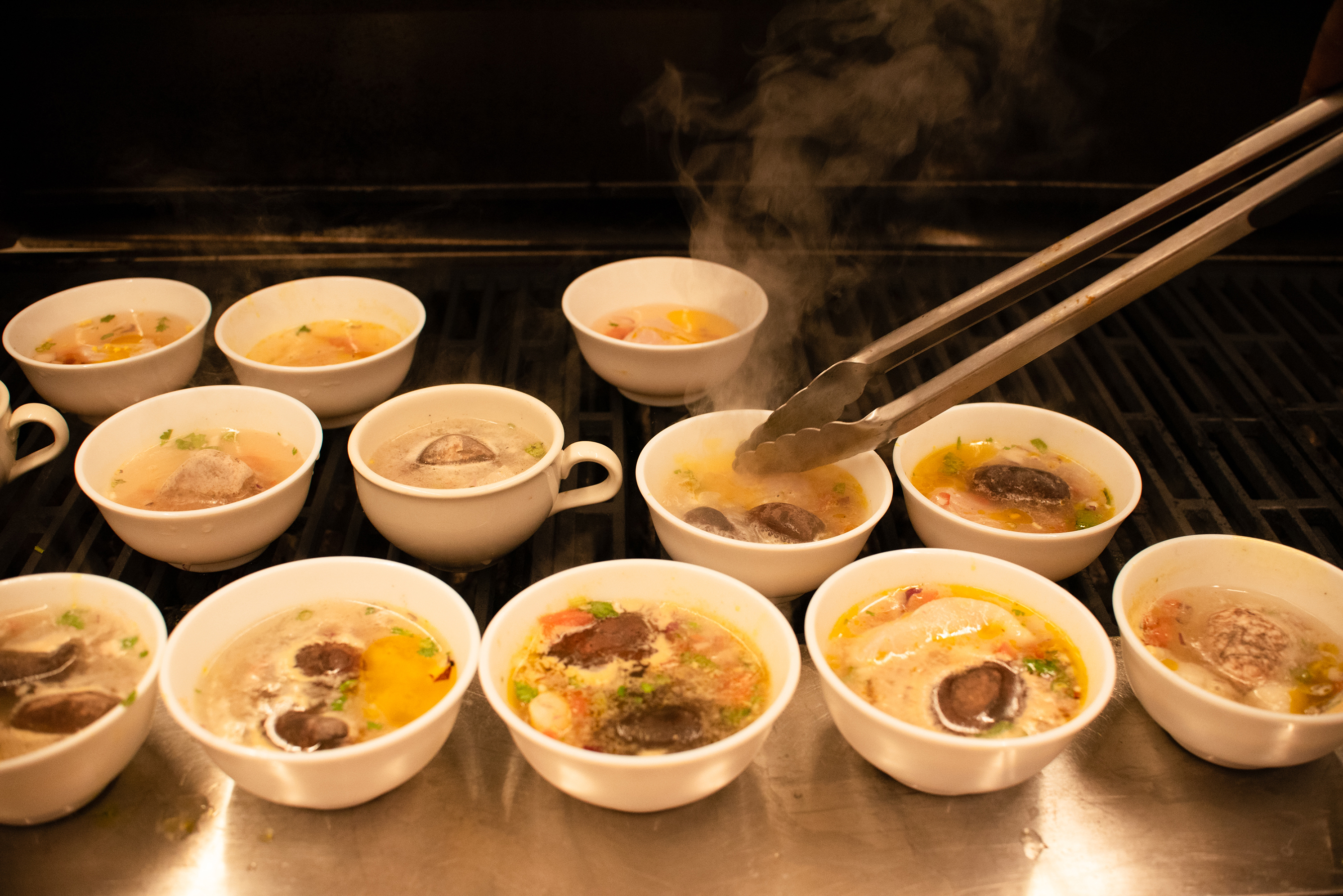 Bhatia prepares individual bowls of soup for community dinner