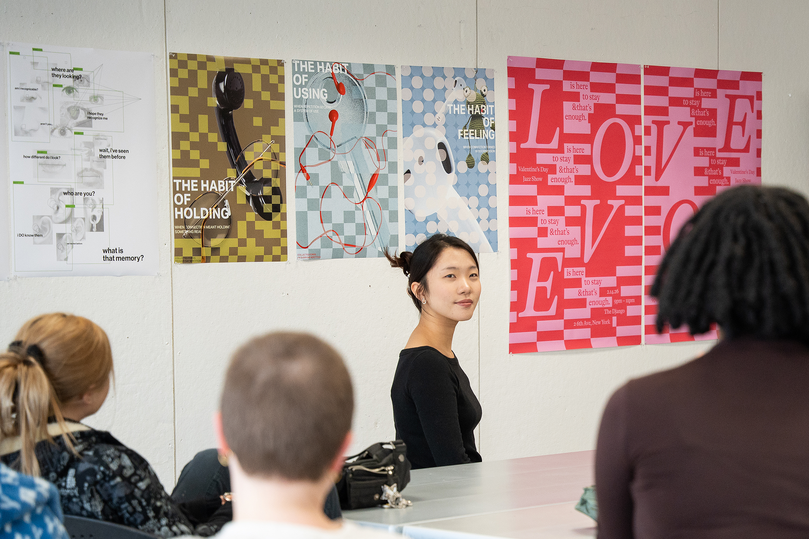 a student listens to feedback about her love poster