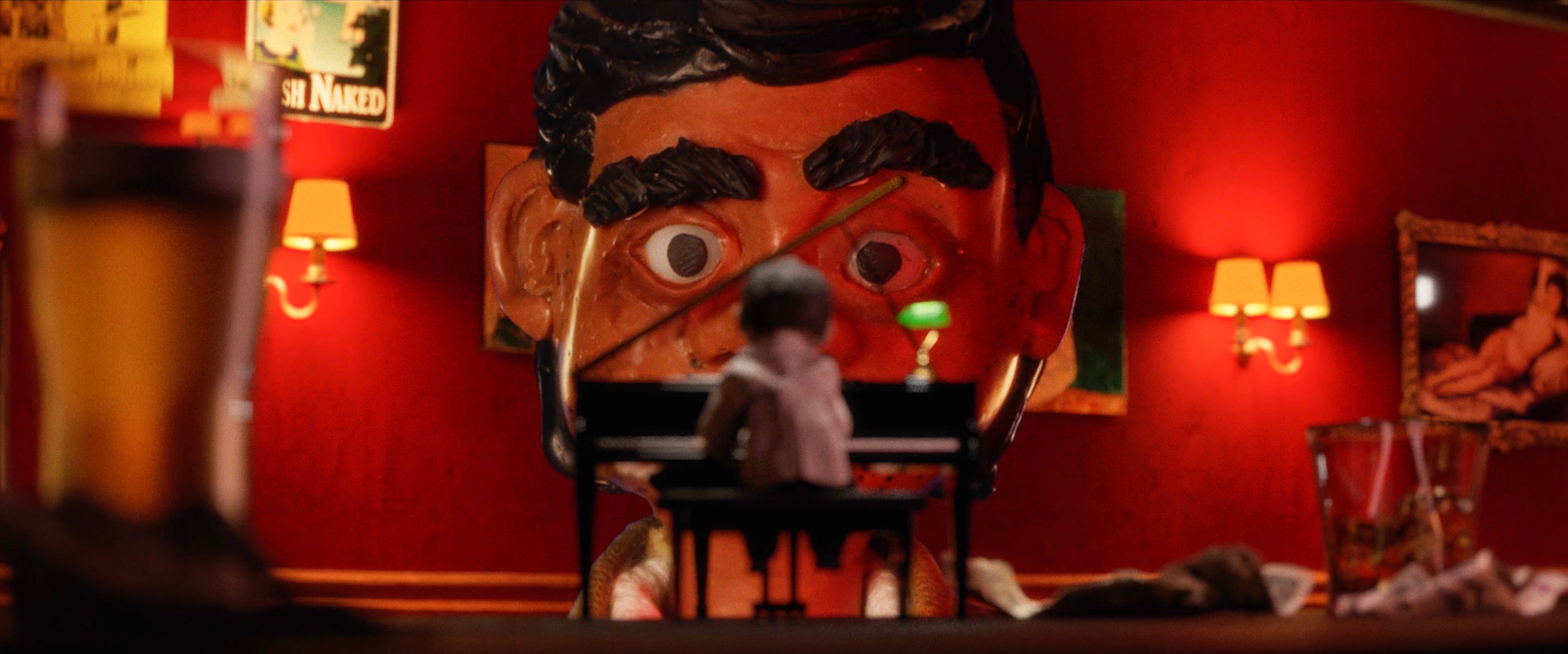 still of protagonist watching pianist play