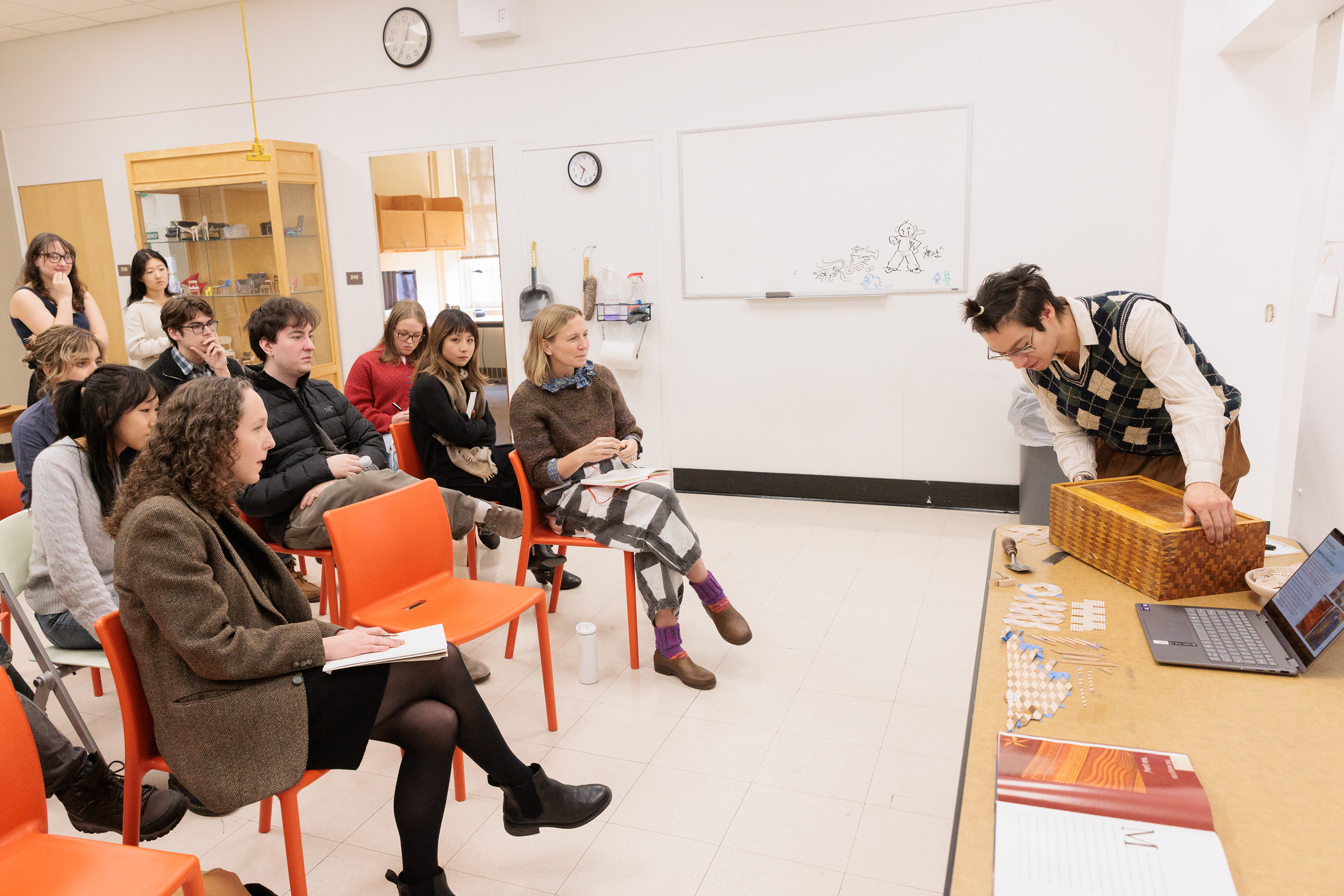 a student presents a marquetry box in crits