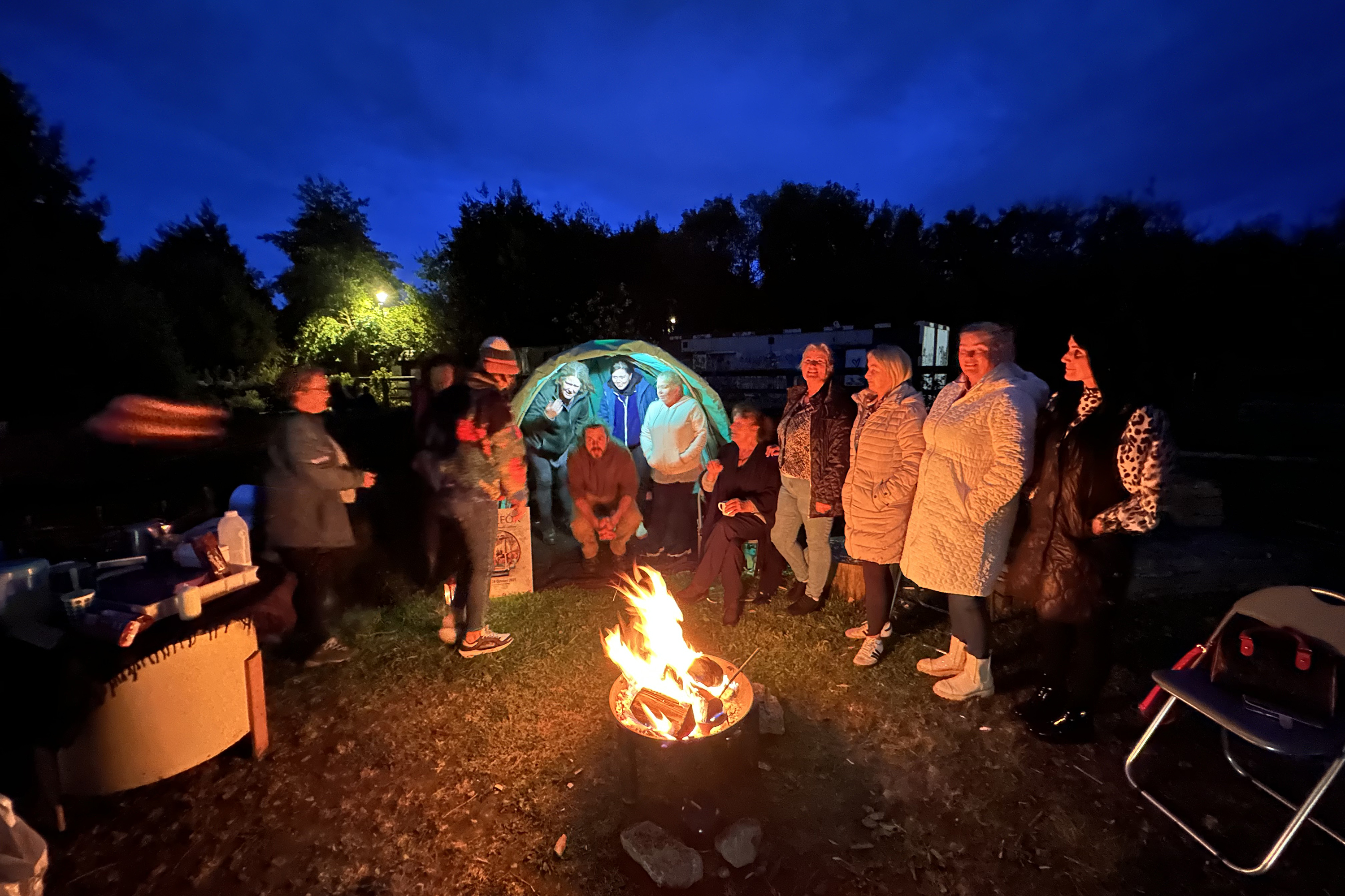 travelers gather around a bonfire in Ireland
