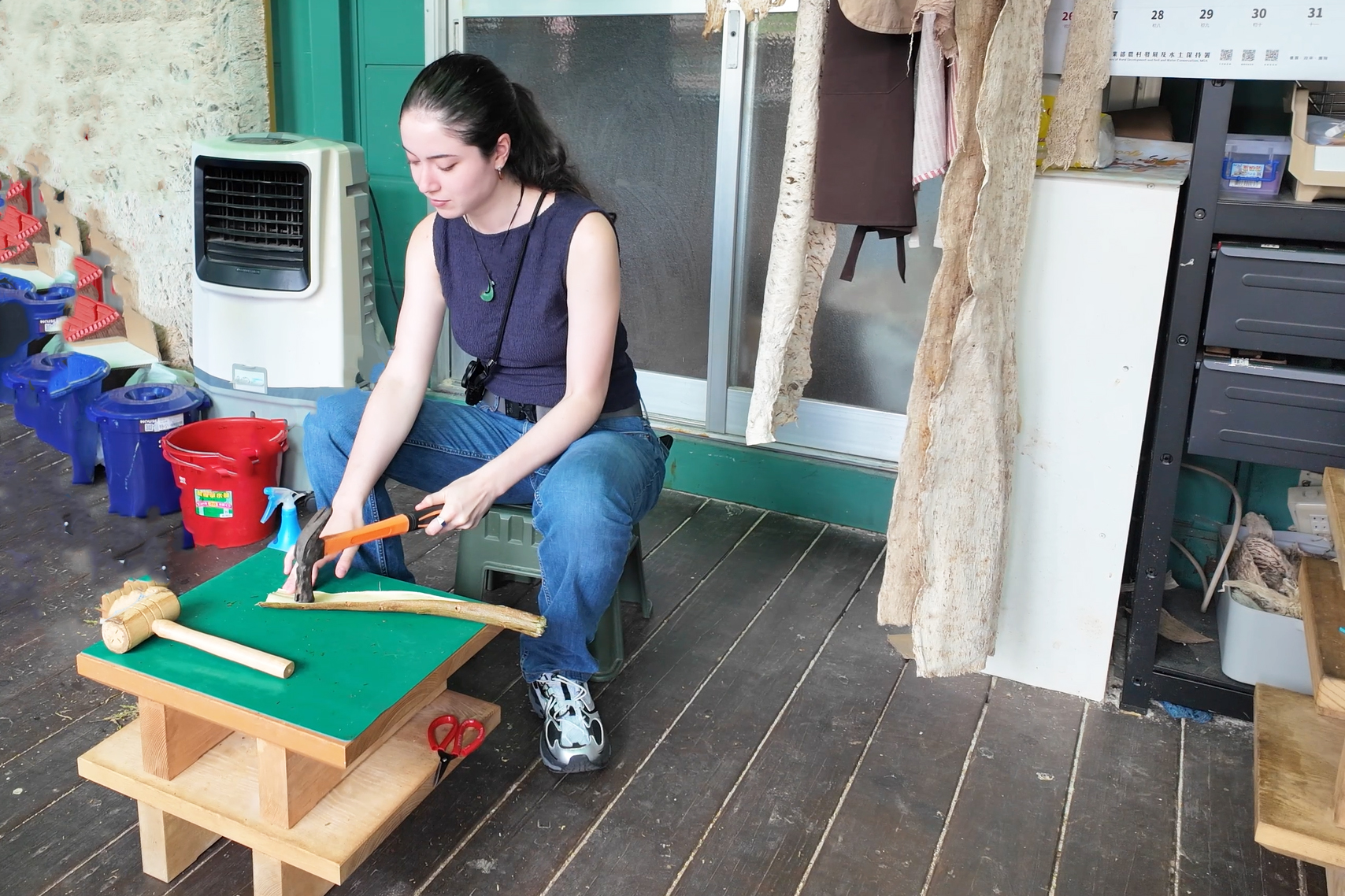 Tybejee works on the legs of her stool in progress