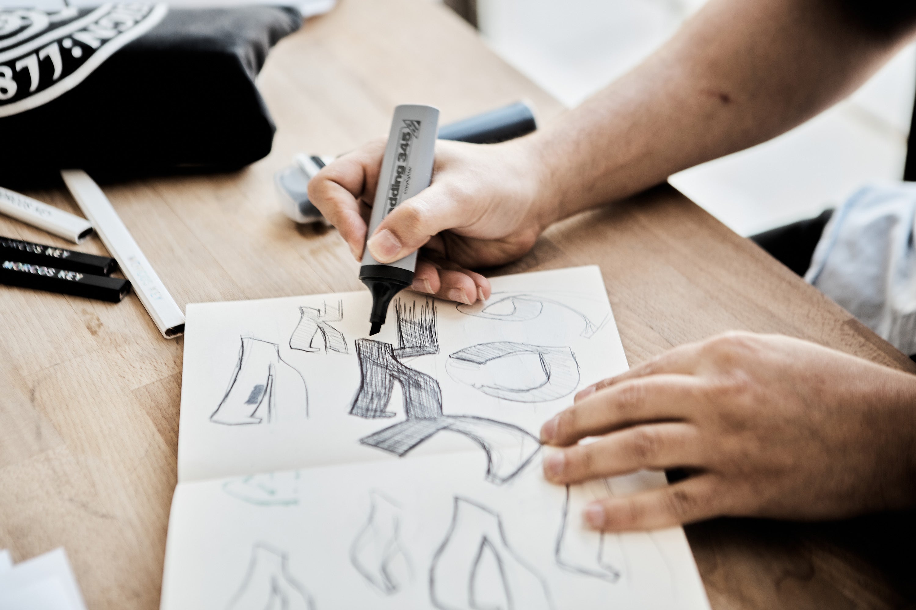 Morcos sketching typeface ideas with a marker