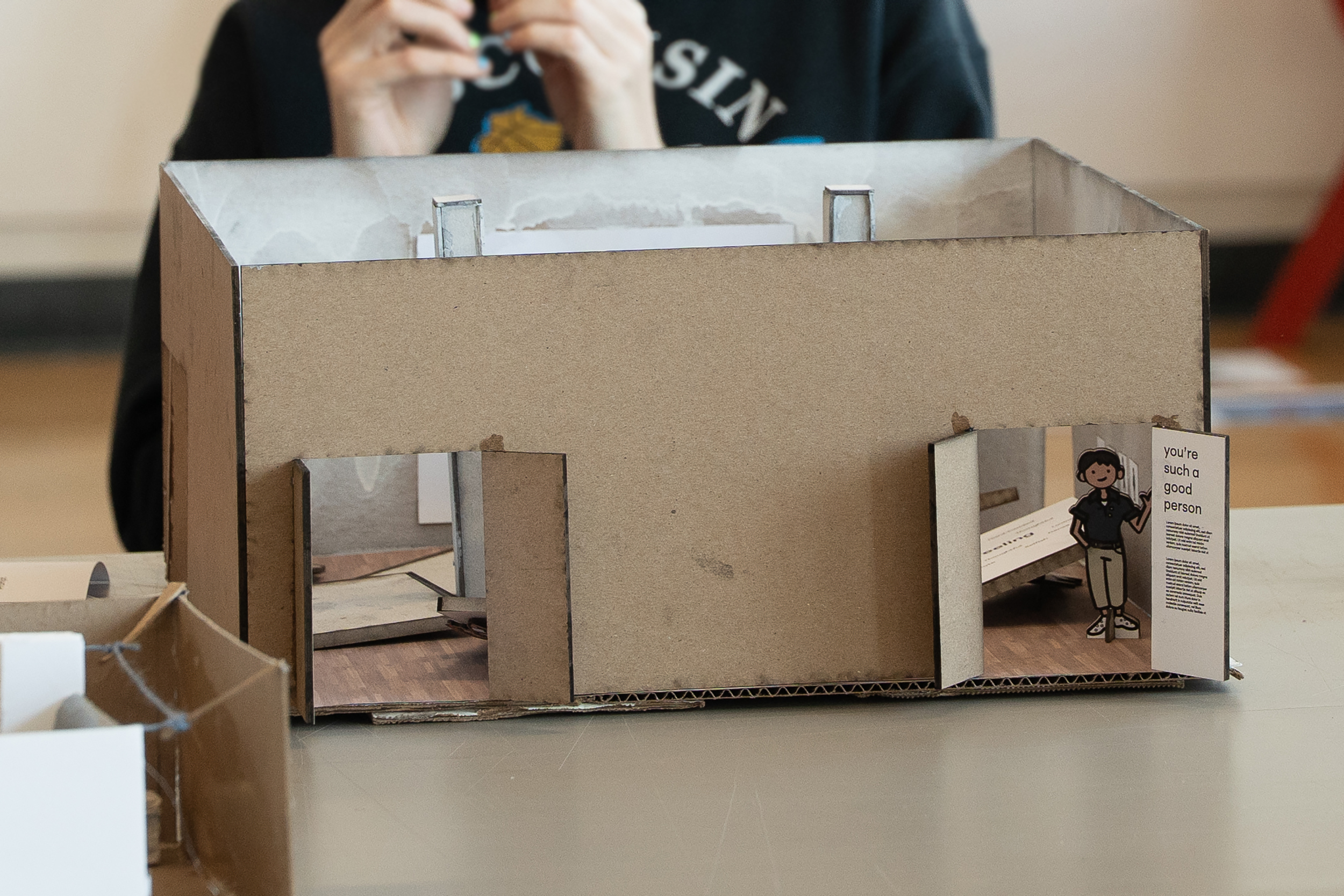 cardboard exhibition model with small human figure