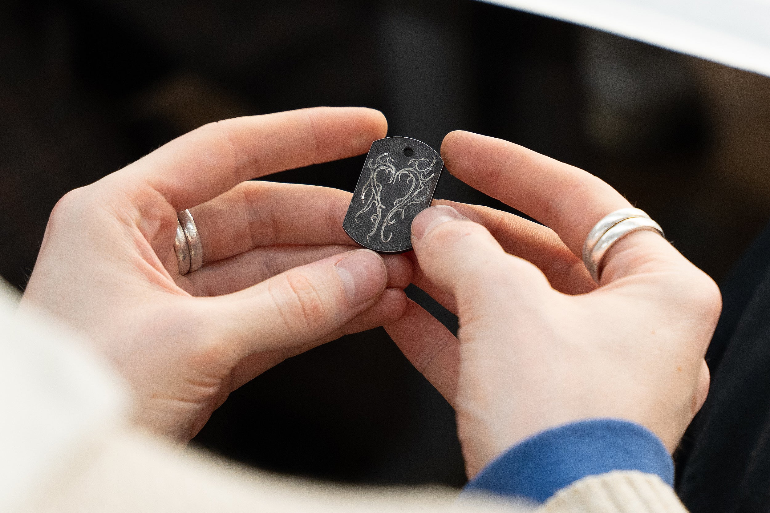 hands holding an engraved key ring