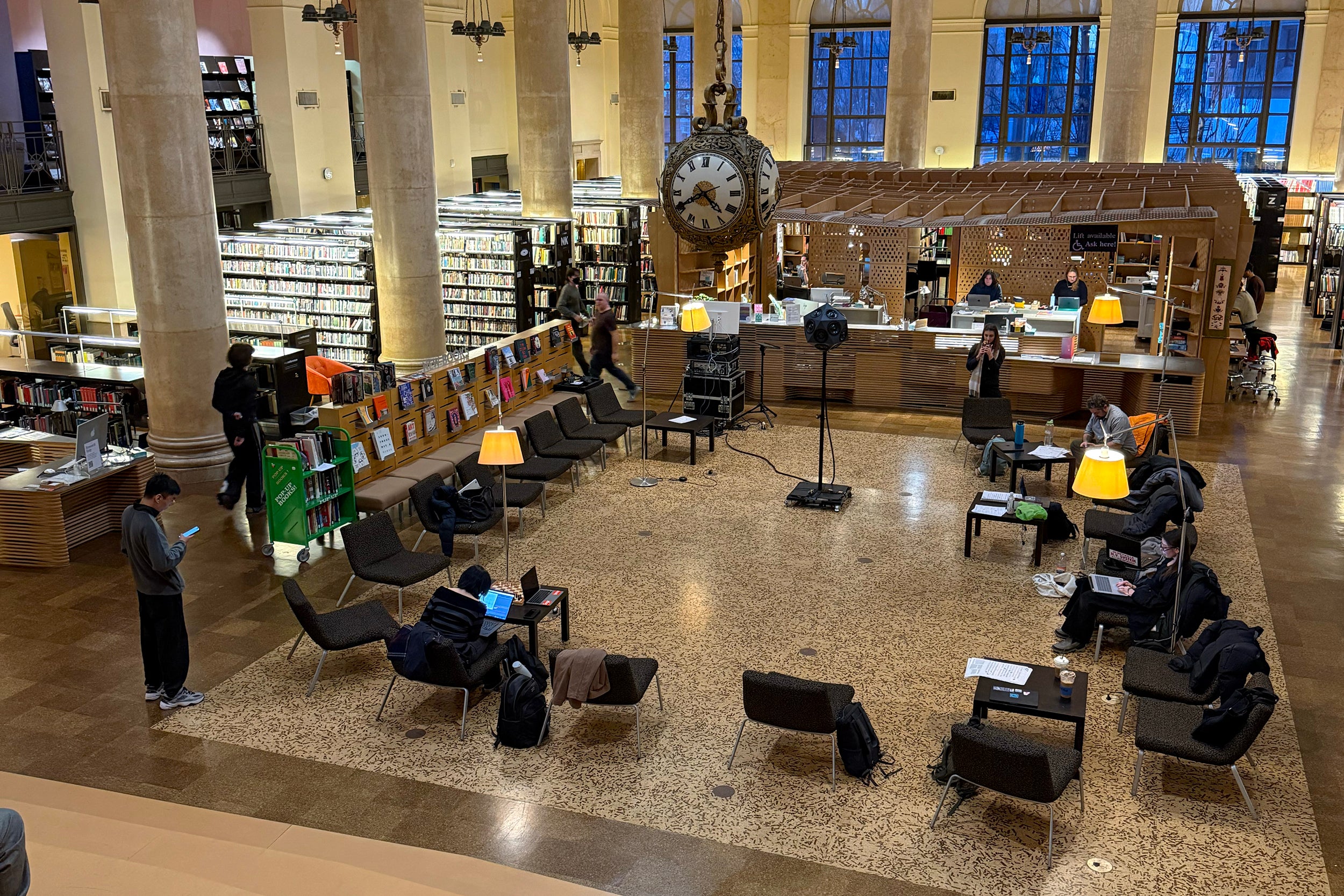 the class gathers in the Fleet Library to hear their compositions