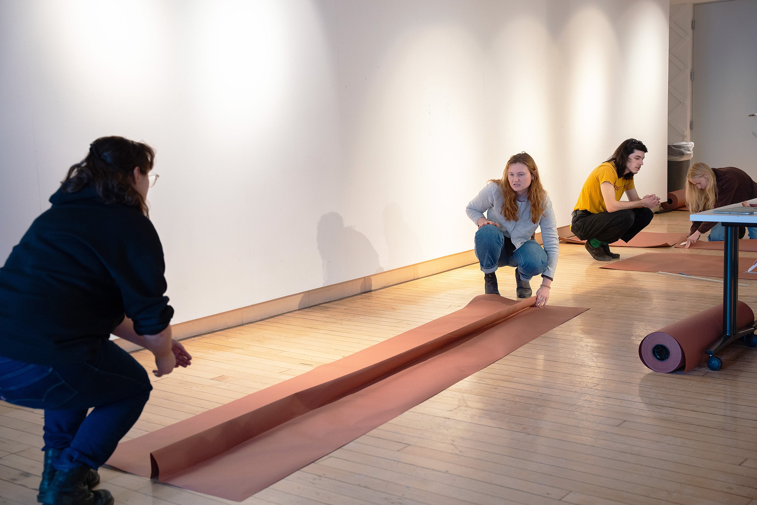 students working together with long rolls of paper