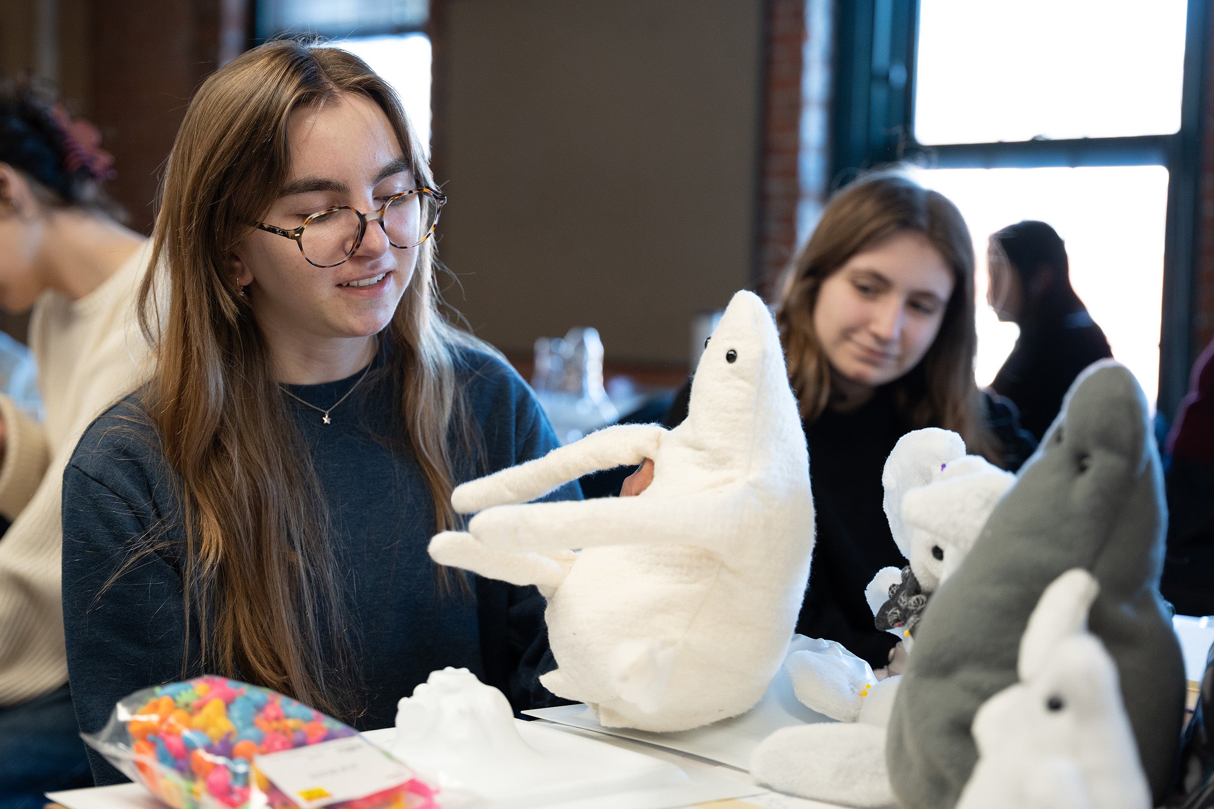 a student presents a series of stuffed toys in studio