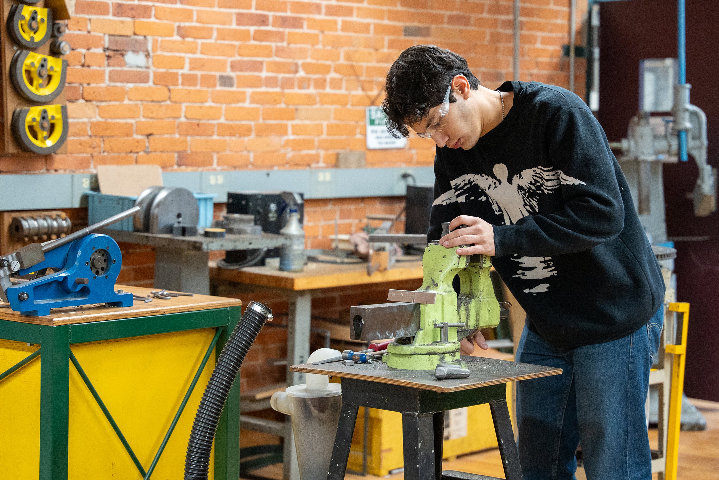 junior Khaled Bushnaq works on his piece at the vice