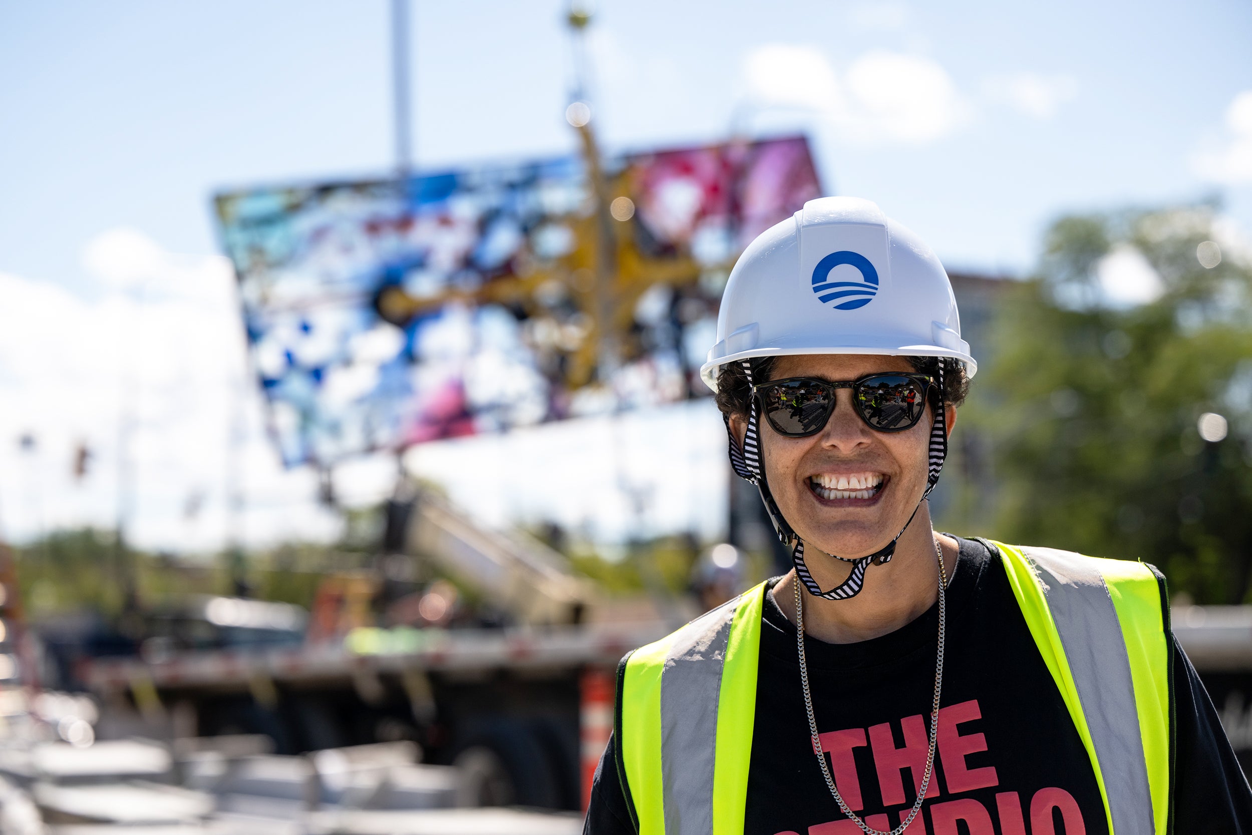Mehretu on-site in Chicago as huge glass piece is lifted by crane in the background