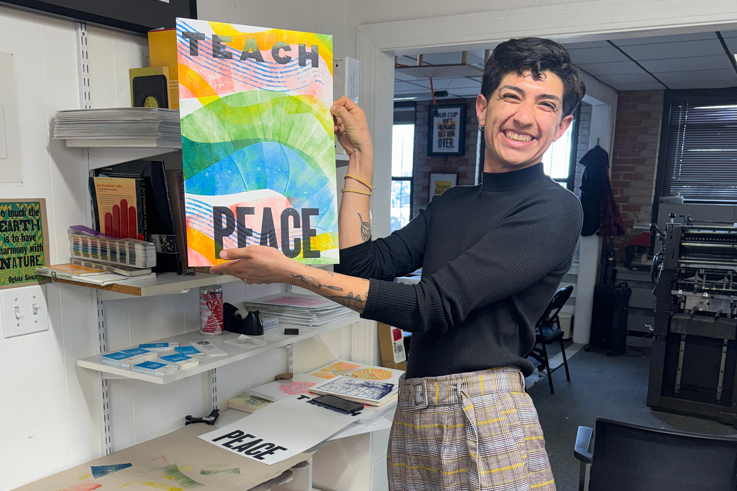 program participants holds up her Teach Peace print