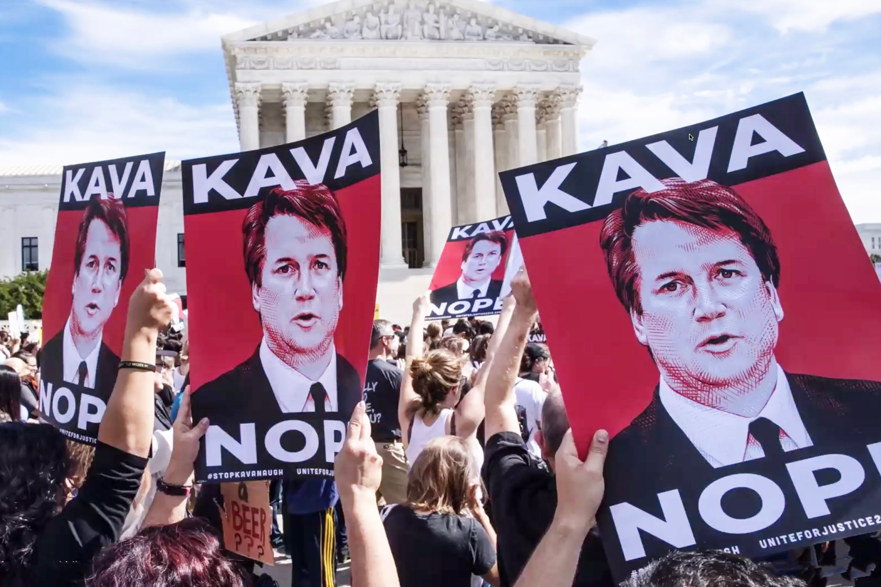 protesters holding KAVANOPE placards