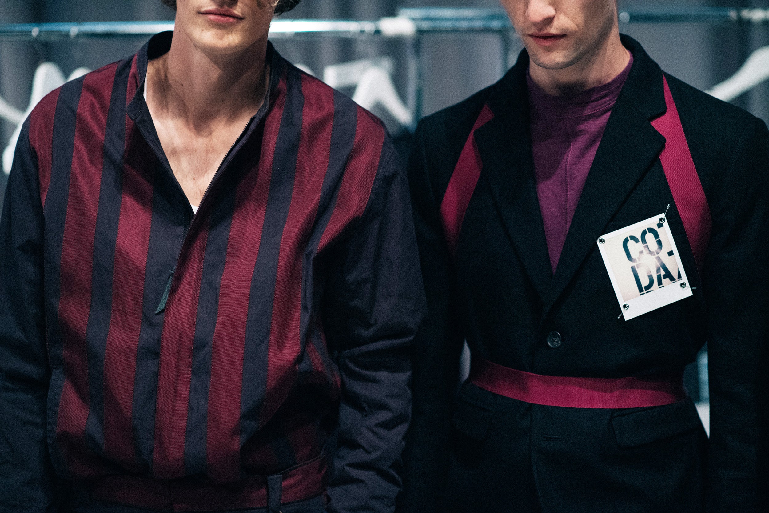 two male models wearing black and magenta attire