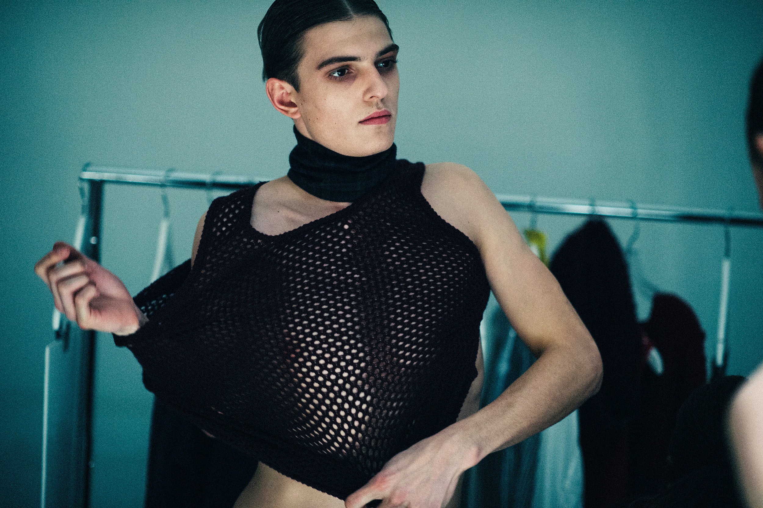 a model getting dressed backstage