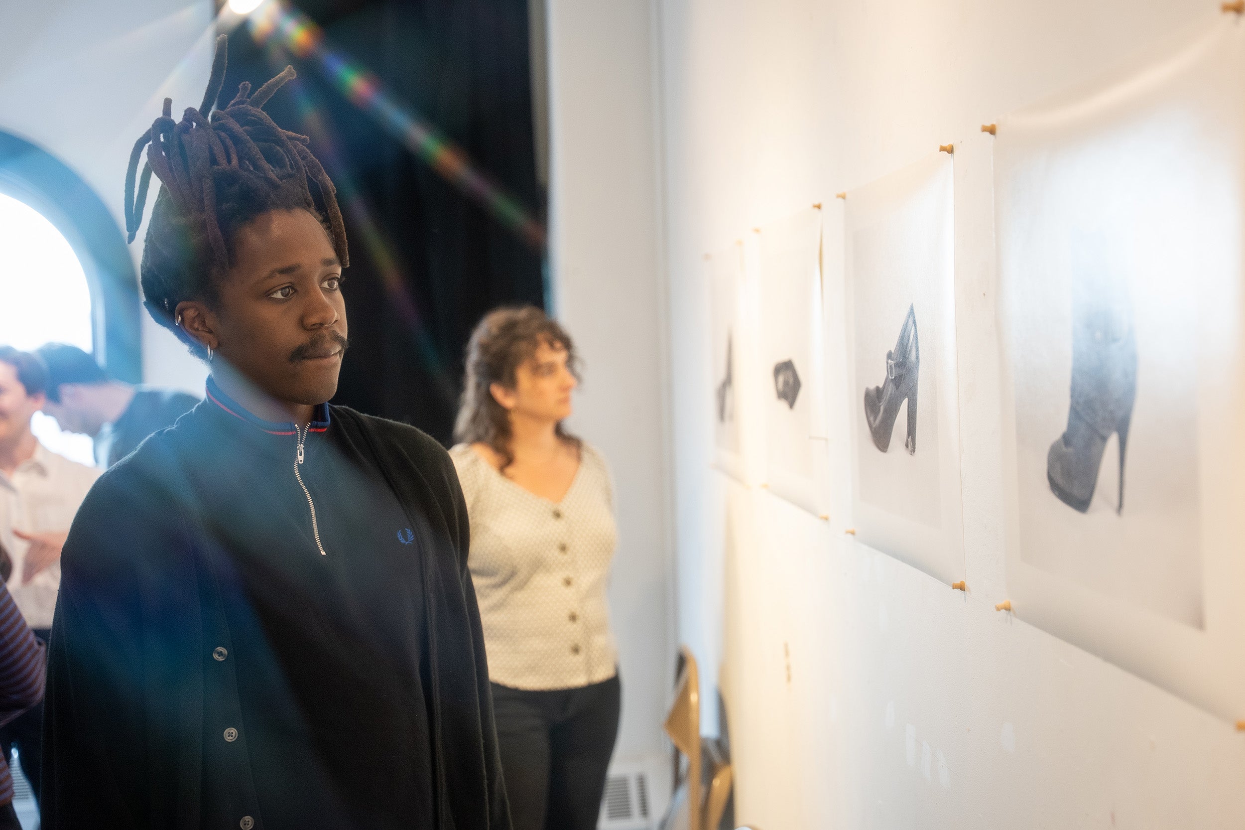 students view work by the peers in grad-level critique