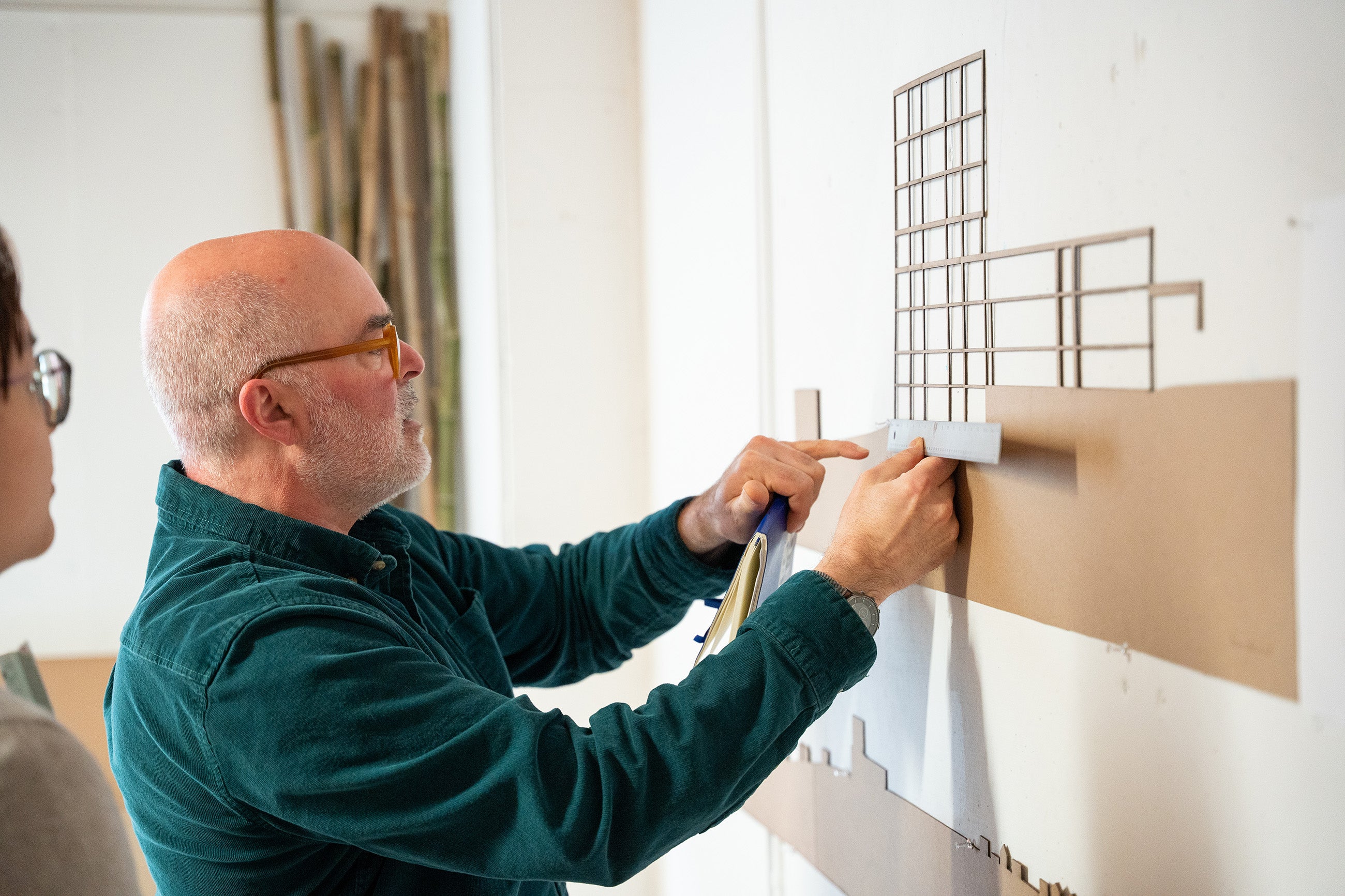 faculty member Jonathan Bell stops to take a site measurement