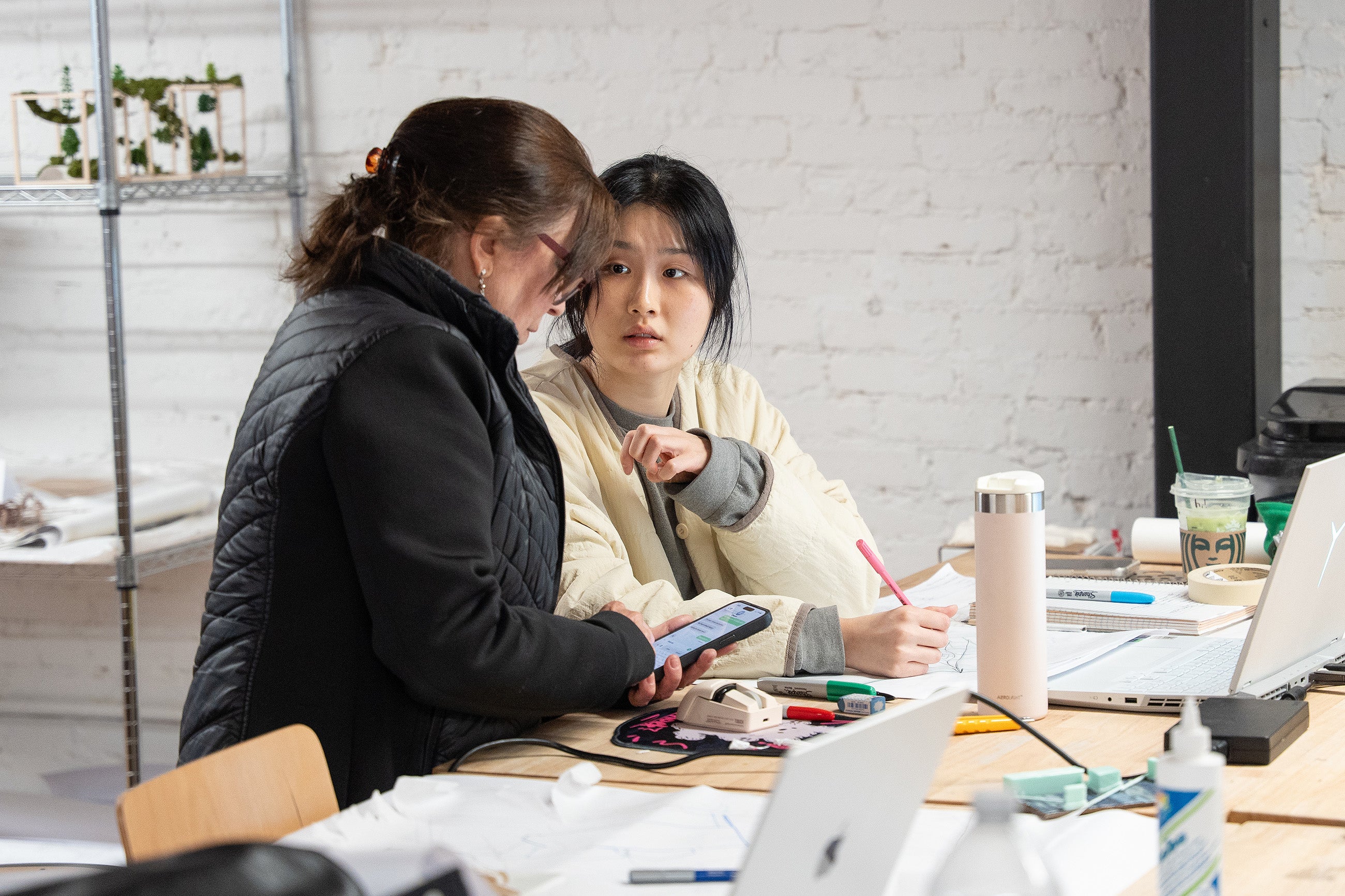 Professor Lili Hermann works with a student