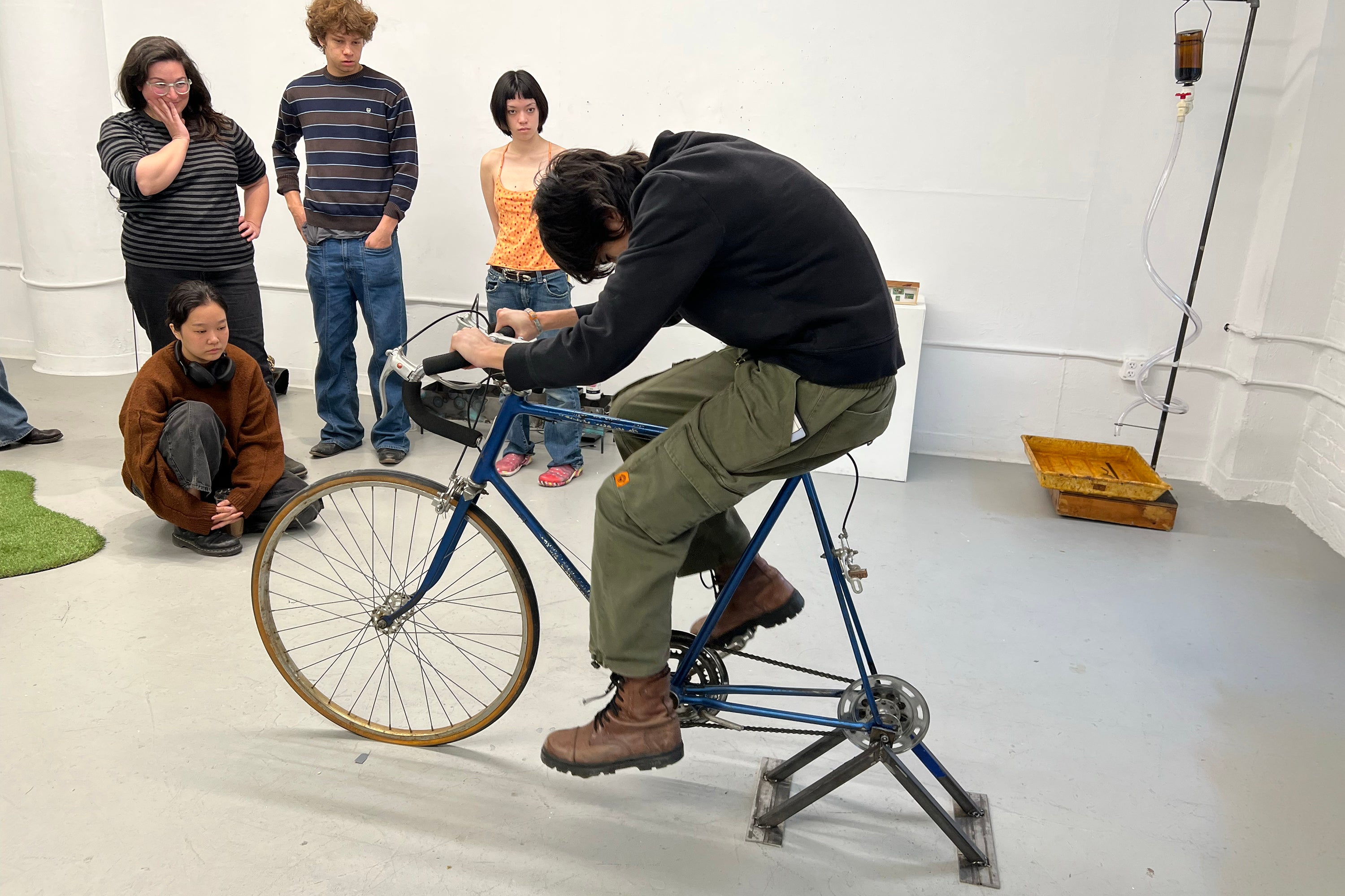 a student pedals a bicycle bolted to the ground