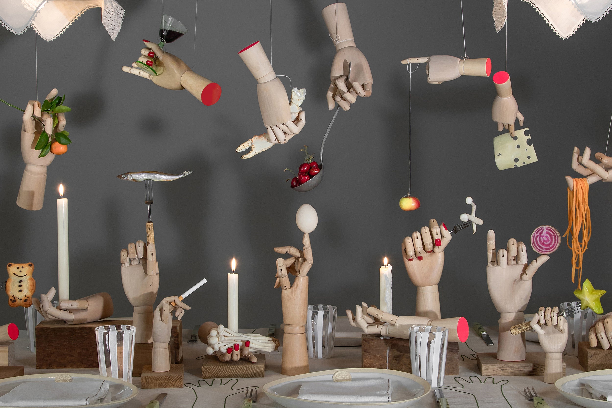 display of mannequin hands holding different bits of food