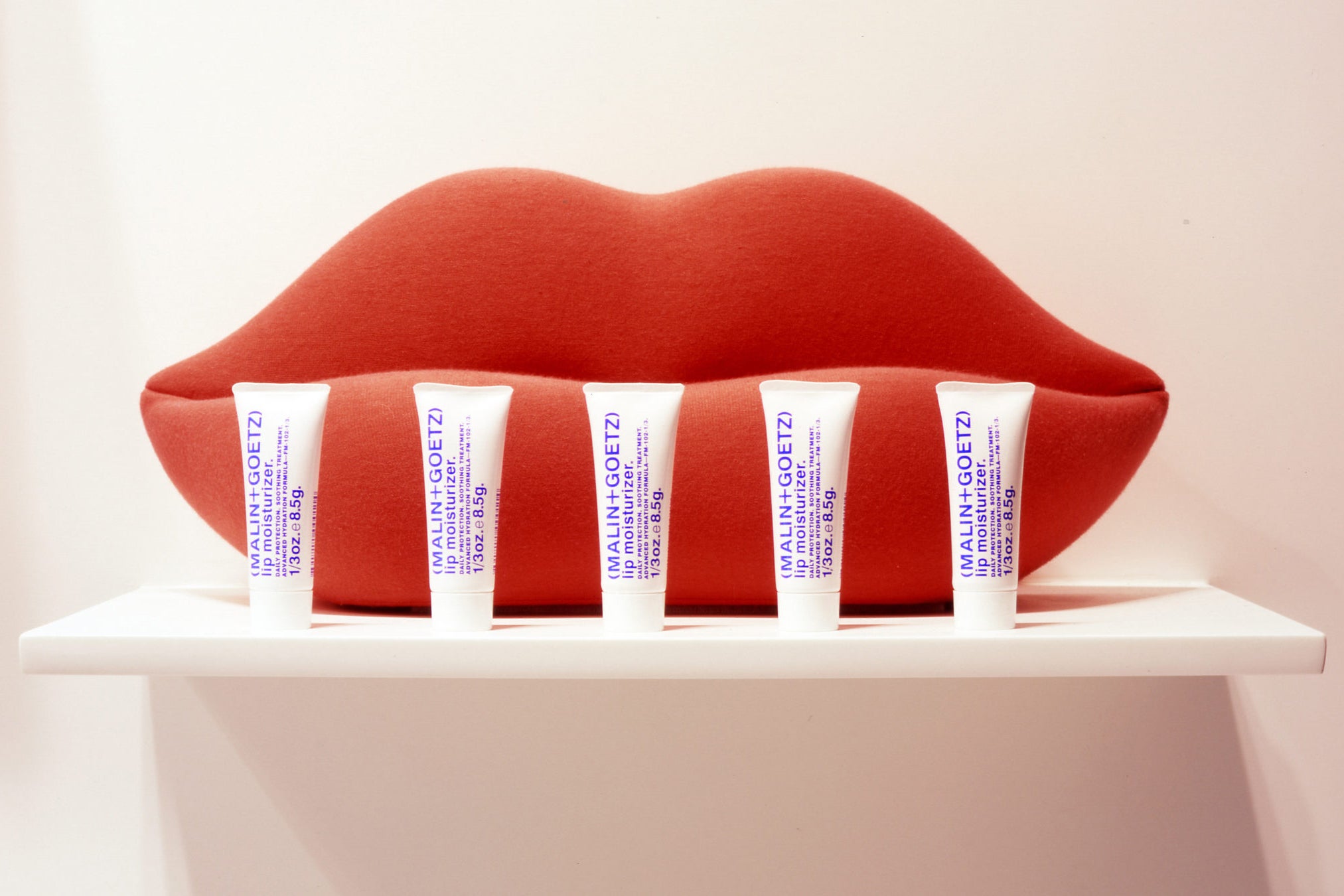 lip moisturizer packaging and display with big red lips