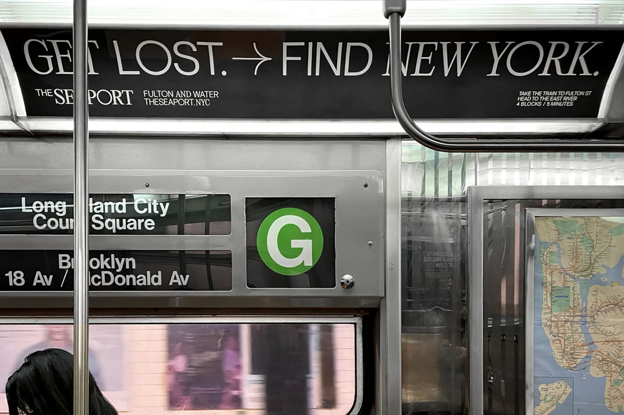 ad for the Seaport inside a moving NYC subway car