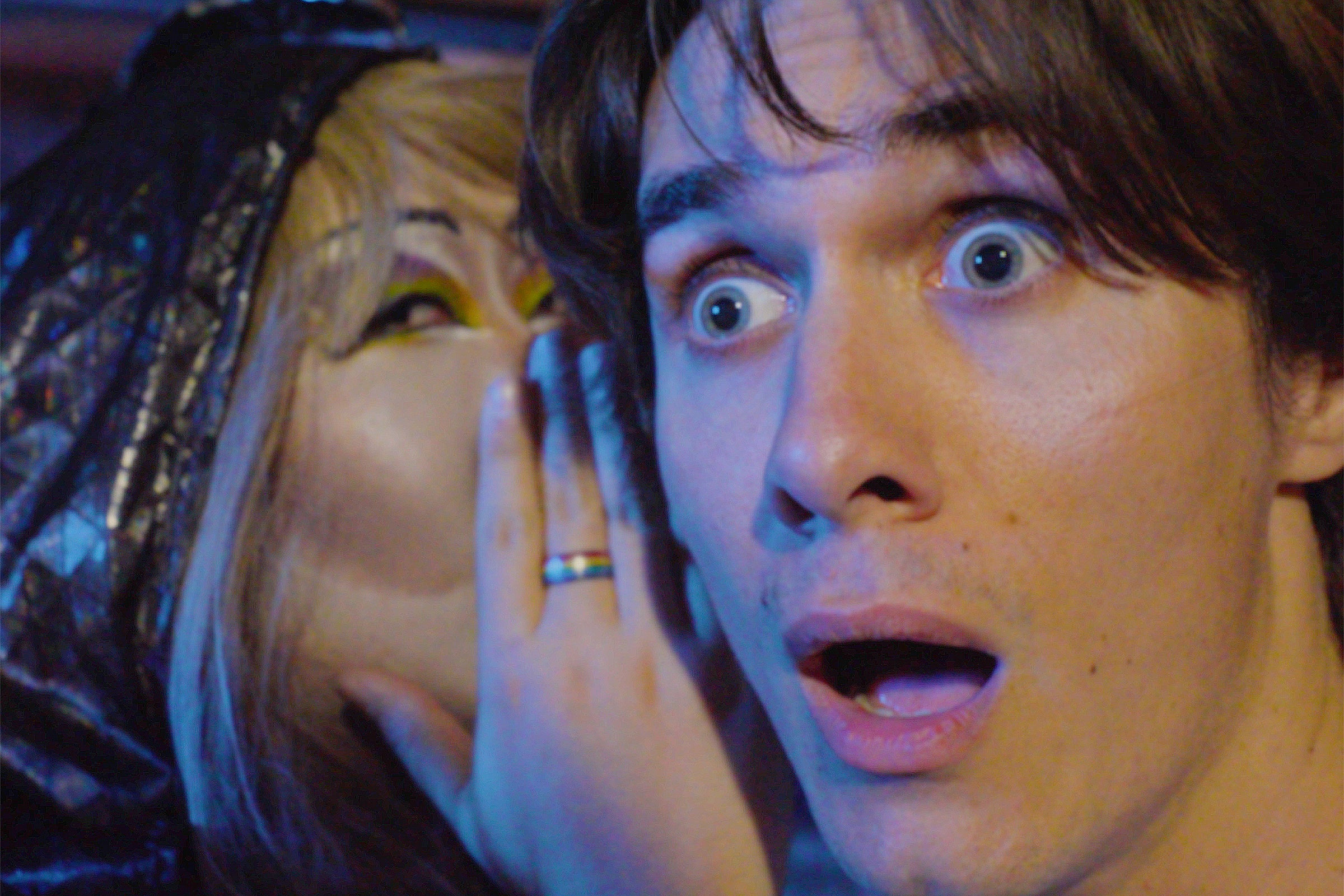 a man has a shocking secret whispered into his ear
