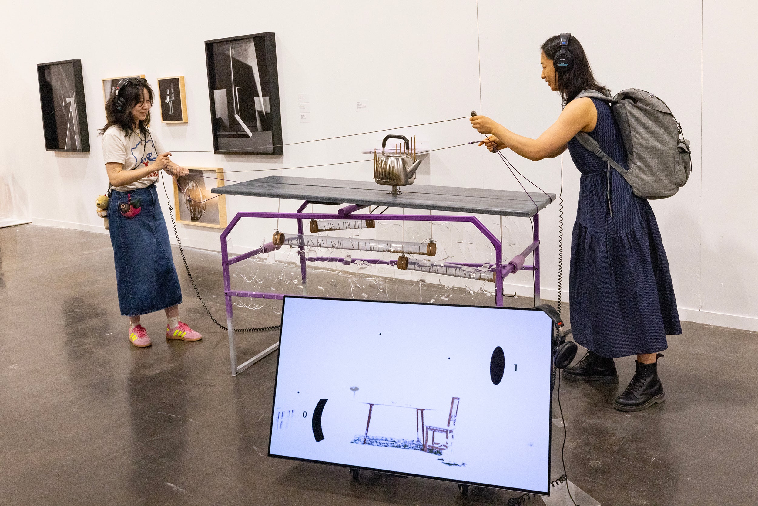 two people interact with Digital + Media installation