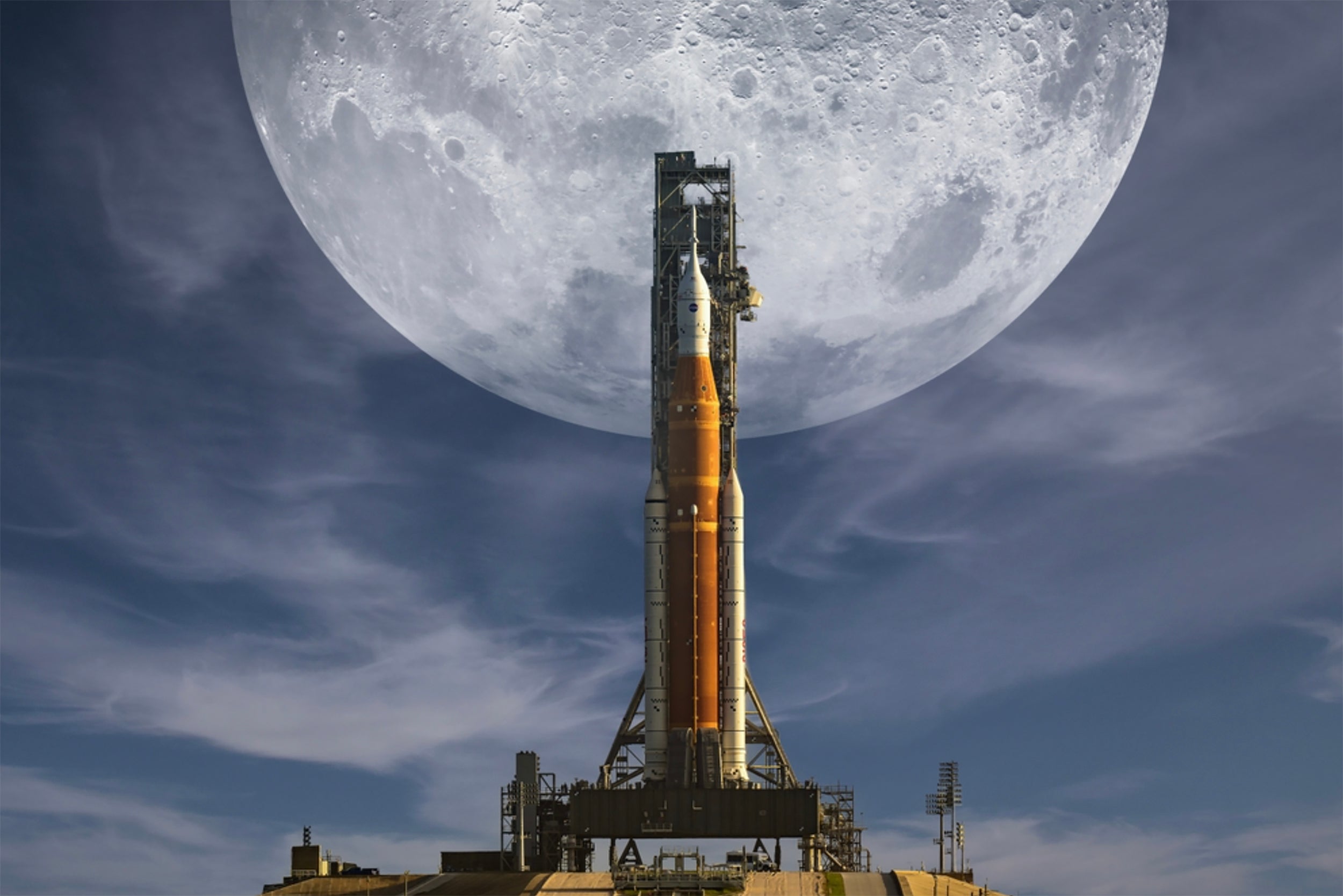 Artemis rocket ship ready for launch in front of a huge full moon