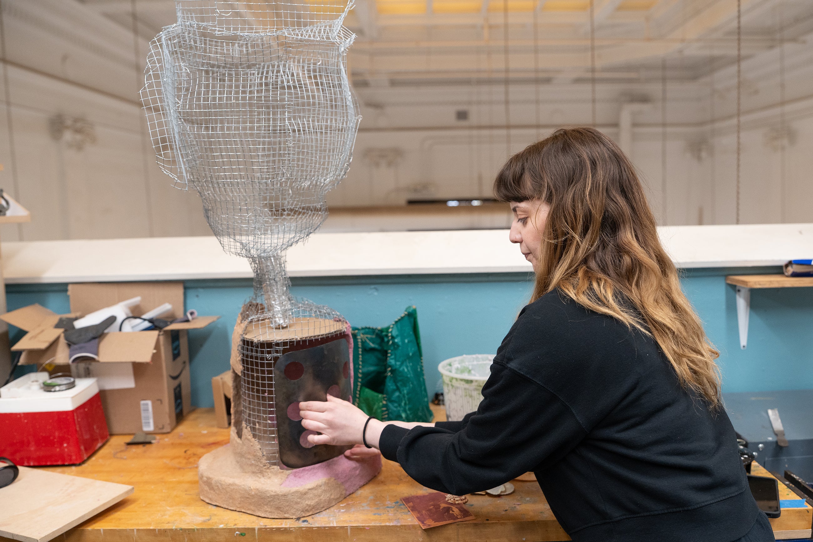 grad student Adi Asia at work on a piece inspired by the Lippitt House