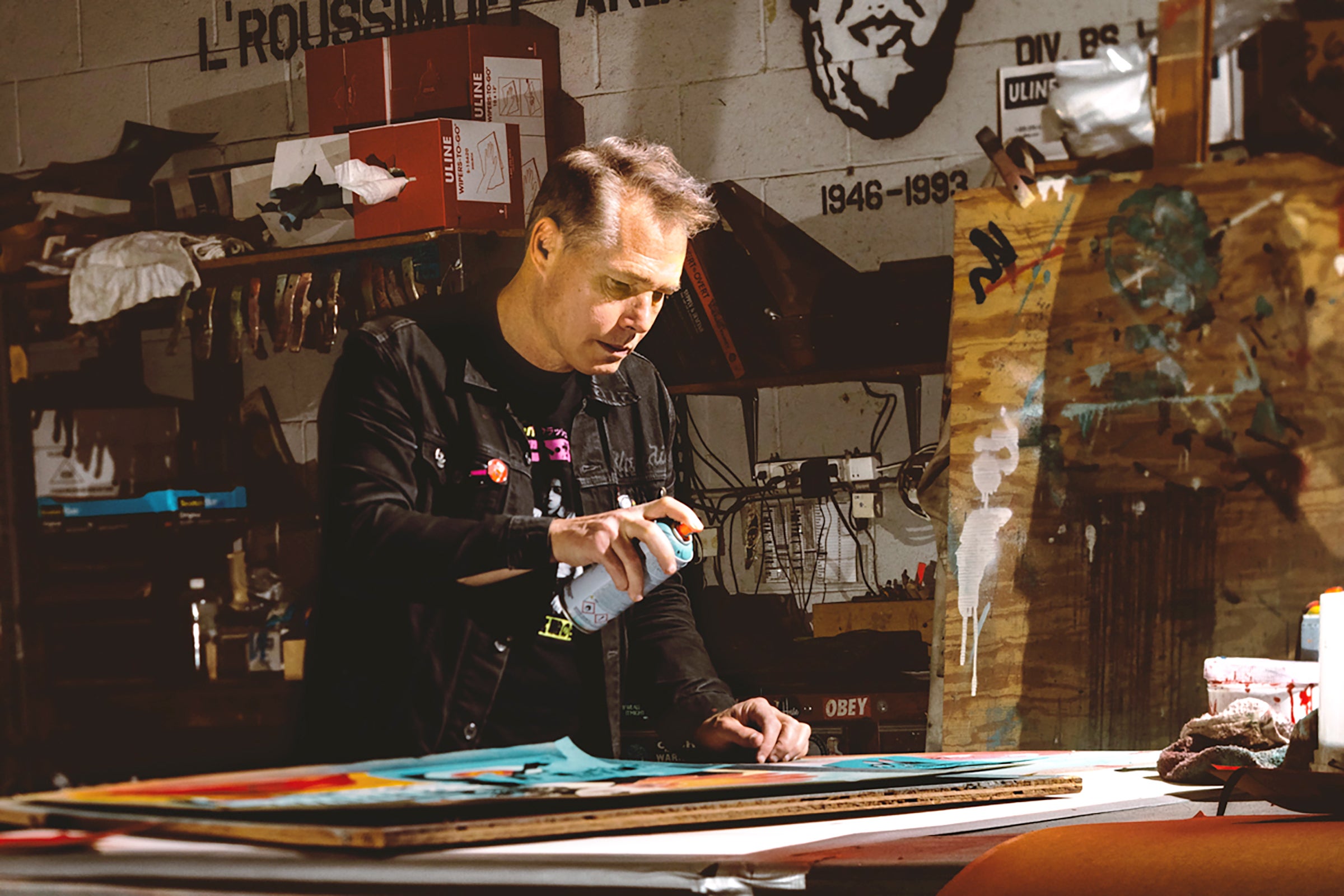 Fairey spraying a piece in his studio