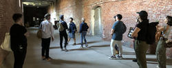 students gathered in a brick hallway