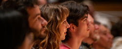 A group of people are listening at an event in RISD auditorium.