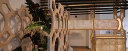 an interlocking set of geometrically crafted wood structures inside a gallery space