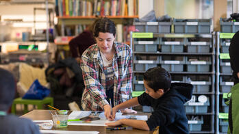 a RISD student working with young children in a classroom setting