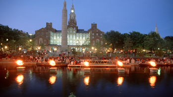 torches lit along the river at night during a WaterFire Providence event