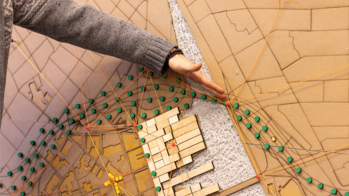 An arm pointing to a modeled design grid