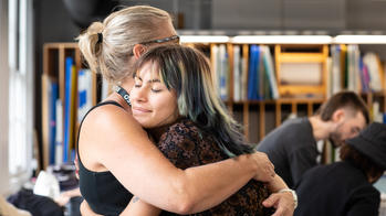 student hugging parent