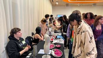 Photo of a student selling jewelry at a table
