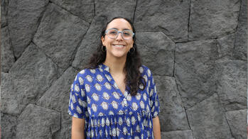 Emilia Lopez Filloy standing in front of a stone wall