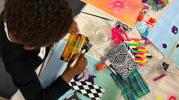 Eagle eye view of a children working on art projects at a mini makerz event.