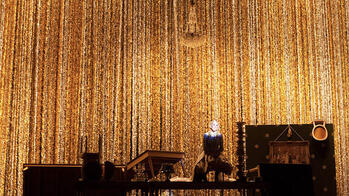 gold beaded curtain across the stage