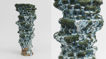 a tall abstract ceramics piece in shades of teal