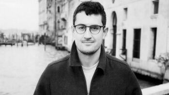 the artist pictured in front of a canal