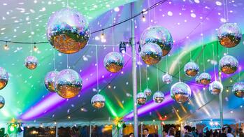 Purple and green light reflects off of disco balls at RISD's 2025 Artist Party.