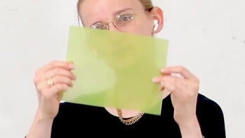 McCurdy holds up a green biomaterial