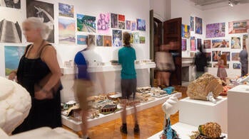 visitors admiring Pre-College student work in the gallery