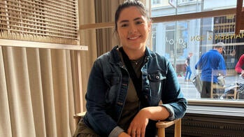 Jessica Cortes seated in a gallery window